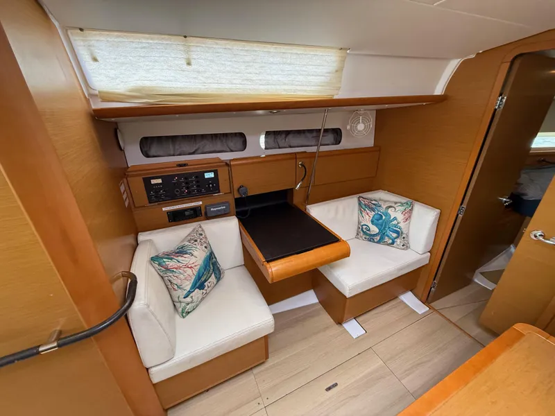 Slide: The Image of Interior of 2015 Jeanneau 409 sailboat with cozy seating and nautical-themed cushions. - 22