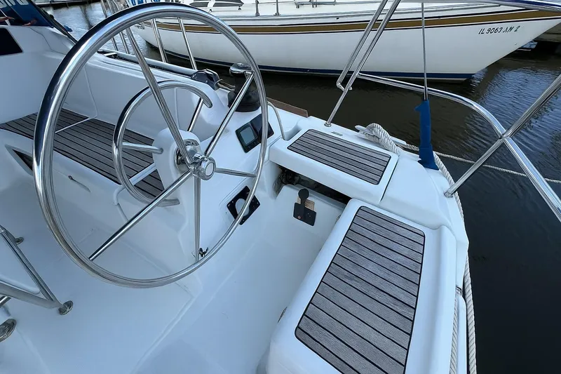 Slide: The Image of Steering wheel and seating area of a 2015 Jeanneau 409 sailboat. - 6