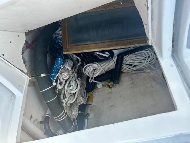 Slide: The Image of Storage compartment on a 1986 Hunter Legend 45 sailboat with ropes and equipment. - 11