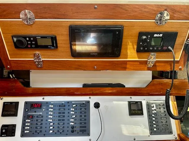 Slide: The Image of Control panel of a 1986 Hunter Legend 45 sailboat with navigation and communication equipment. - 17