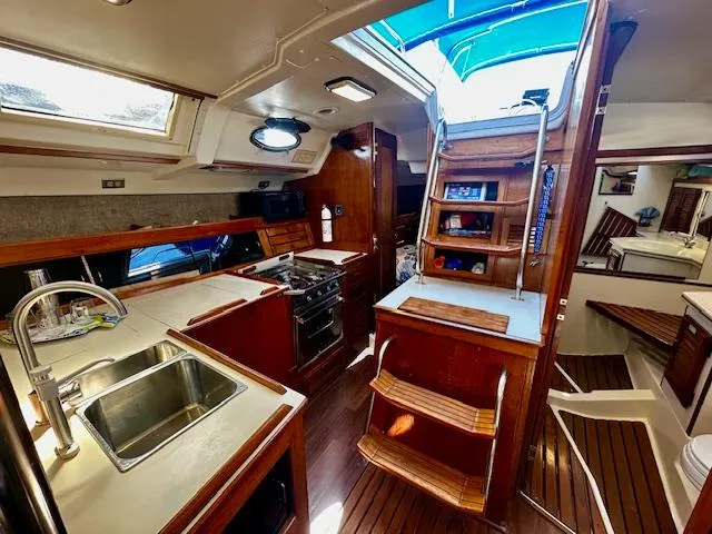 Slide: The Image of Interior of 1986 Hunter Legend 45 sailboat with kitchen and wooden cabinetry. - 20