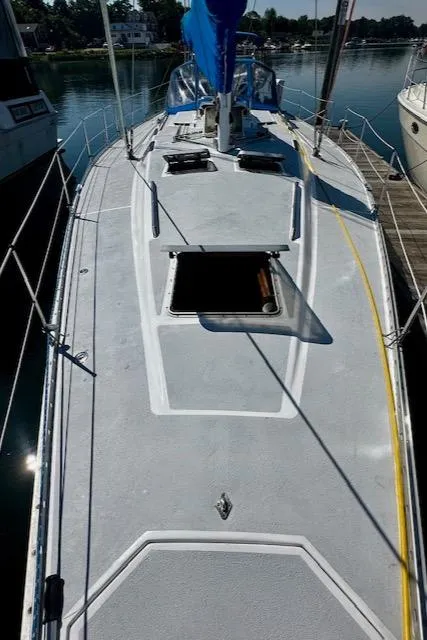 Slide: The Image of 1986 Hunter Legend 45 sailboat docked, showing deck and open hatch. - 27