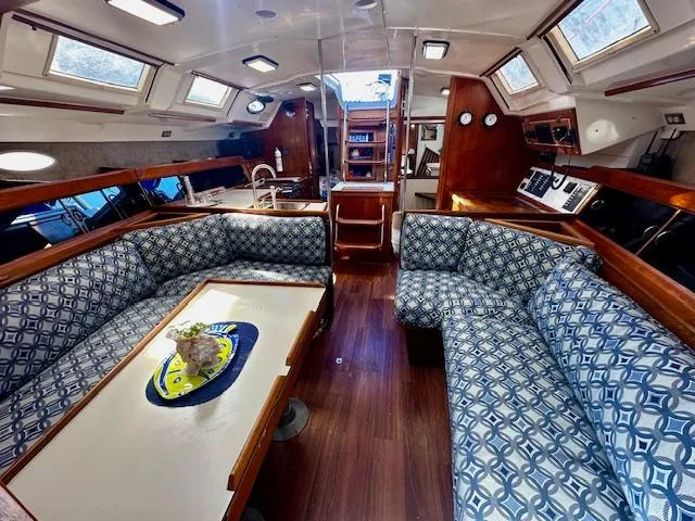 Slide: The Image of Interior of 1986 Hunter Legend 45 sailboat with patterned seating and wooden accents. - 3