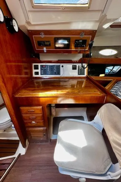 Slide: The Image of 1986 Hunter Legend 45 yacht interior with navigation station and wooden desk. - 31