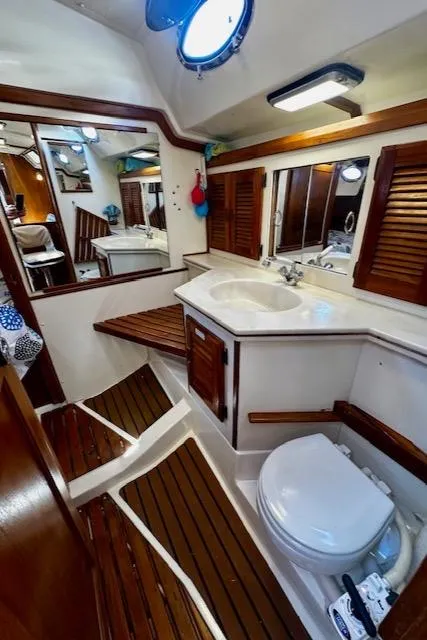Slide: The Image of 1986 Hunter Legend 45 yacht bathroom with wooden accents and modern fixtures. - 32