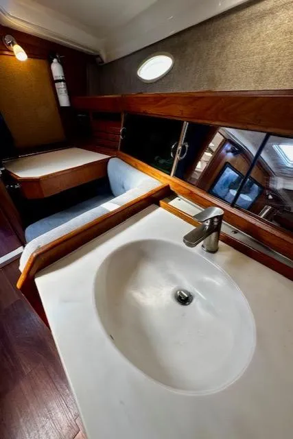 Slide: The Image of 1986 Hunter Legend 45 yacht interior with sink, wooden accents, and seating area. - 36
