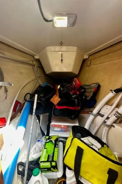 Slide: The Image of Cluttered storage area inside a 1986 Hunter Legend 45 sailboat. - 38
