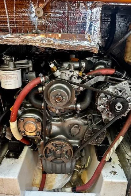 Slide: The Image of Engine of a 1986 Hunter Legend 45 sailboat, featuring belts and hoses. - 42