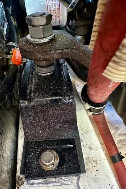 Slide: The Image of Engine component of 1986 Hunter Legend 45 sailboat, featuring bolts and red cables. - 43