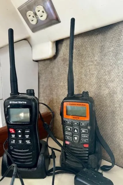 Slide: The Image of Two marine radios on a Hunter Legend 45, 1986 model, with power outlet nearby. - 45