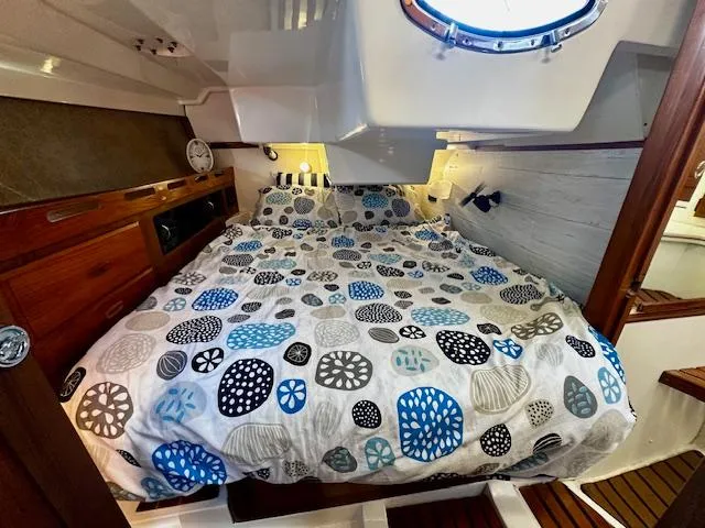 Slide: The Image of Cozy cabin interior of 1986 Hunter Legend 45 sailboat with patterned bedding and wooden accents. - 6