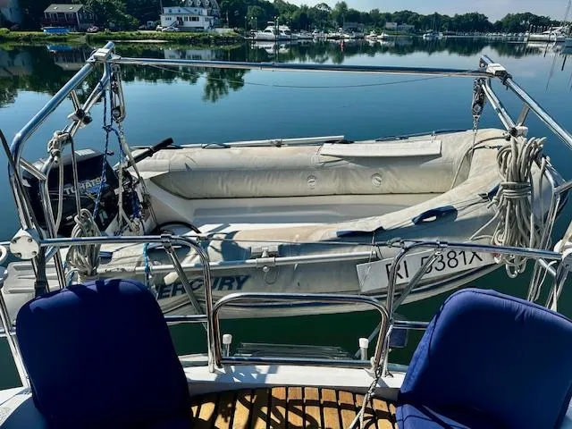 Slide: The Image of Hunter Legend 45 sailboat with inflatable dinghy on calm water, 1986 model. - 9