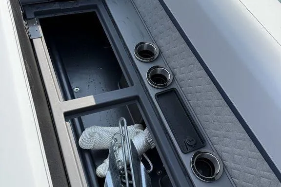 Slide: The Image of Interior of 2026 Bennington M Quad Bench 24 MFB with storage compartment and cup holders. - 10