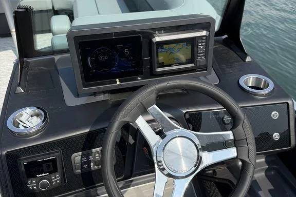 Slide: The Image of Steering console of 2026 Bennington M Quad Bench 24 MFB with digital displays and controls. - 12