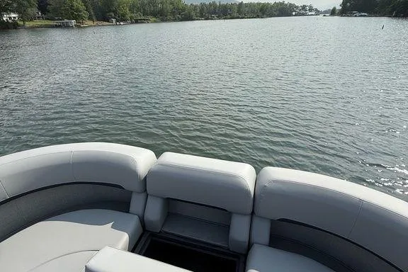 Slide: The Image of 2026 Bennington M Quad Bench 24 MFB on a serene lake. - 15