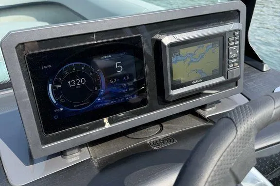 Slide: The Image of Dashboard of 2026 Bennington M Quad Bench 24 MFB with digital displays and navigation system. - 16