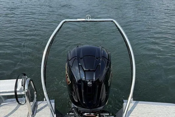 Slide: The Image of 2026 Bennington M Quad Bench 24 MFB boat engine on water. - 8