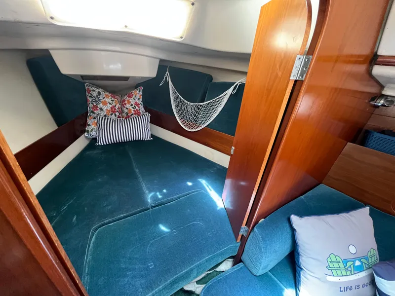 Slide: The Image of Cozy cabin interior of 1998 Beneteau 321 sailboat with cushions and decorative pillows. - 10
