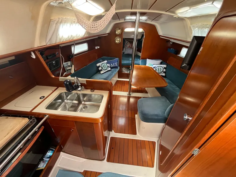 Slide: The Image of Interior of a 1998 Beneteau 321 sailboat with wood finish and cozy seating area. - 11
