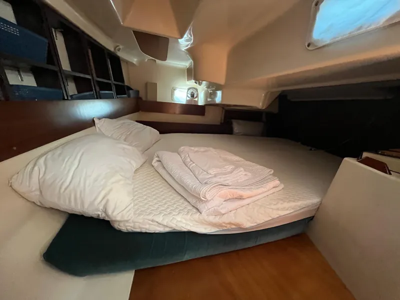 Slide: The Image of Cozy cabin interior of a 1998 Beneteau 321 sailboat with bed and pillows. - 15