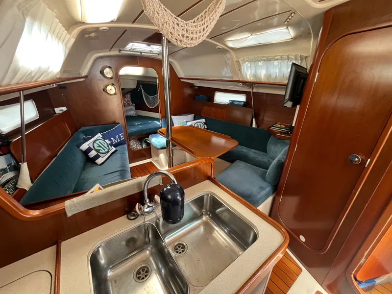 Slide: The Image of Interior of a 1998 Beneteau 321 sailboat with cozy seating and wooden finishes. - 18