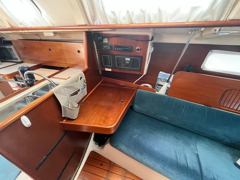 Slide: The Image of Interior of a 1998 Beneteau 321 sailboat with wooden finish and navigation equipment. - 19
