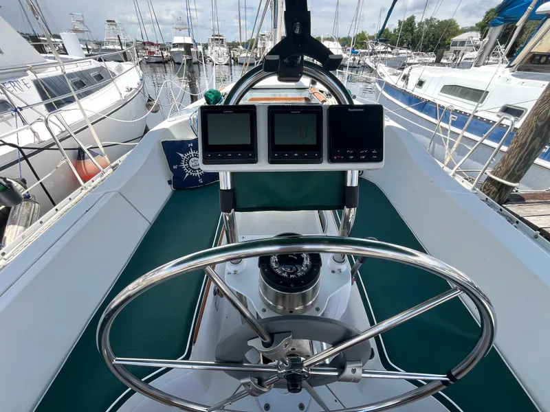 Slide: The Image of Cockpit of 1998 Beneteau 321 sailboat with navigation instruments and steering wheel. - 3