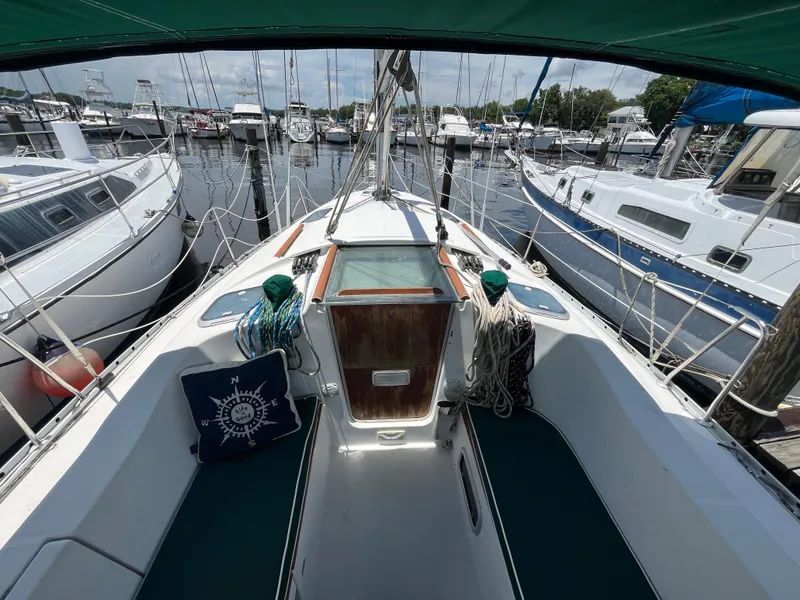 Slide: The Image of Cockpit view of a 1998 Beneteau 321 sailboat docked at a marina. - 7