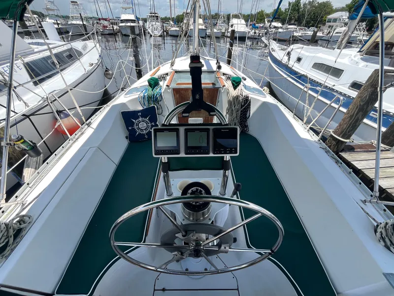 Slide: The Image of Cockpit of a 1998 Beneteau 321 sailboat docked at a marina. - 8