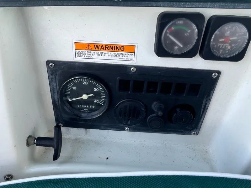 Slide: The Image of Control panel of a 1998 Beneteau 321 sailboat with gauges and warning label. - 9