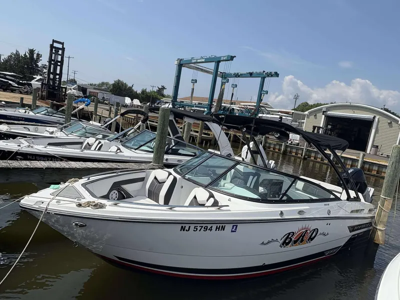 The Image of 2021 Monterey 255 Super Sport boat docked at a marina under a clear sky. - 1