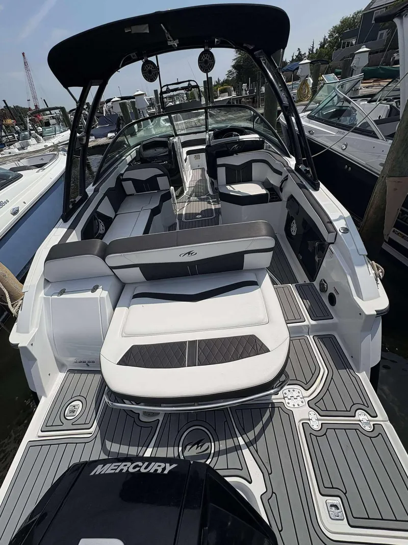 Slide: The Image of 2021 Monterey 255 Super Sport boat with sleek seating and modern design at a marina. - 14