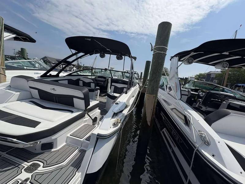 Slide: The Image of 2021 Monterey 255 Super Sport boat docked, featuring sleek design and comfortable seating. - 15