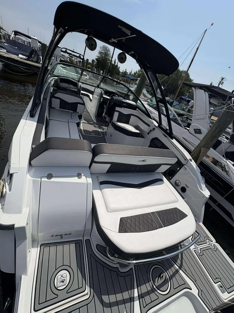 Slide: The Image of 2021 Monterey 255 Super Sport boat with sleek seating and modern design at a marina. - 16