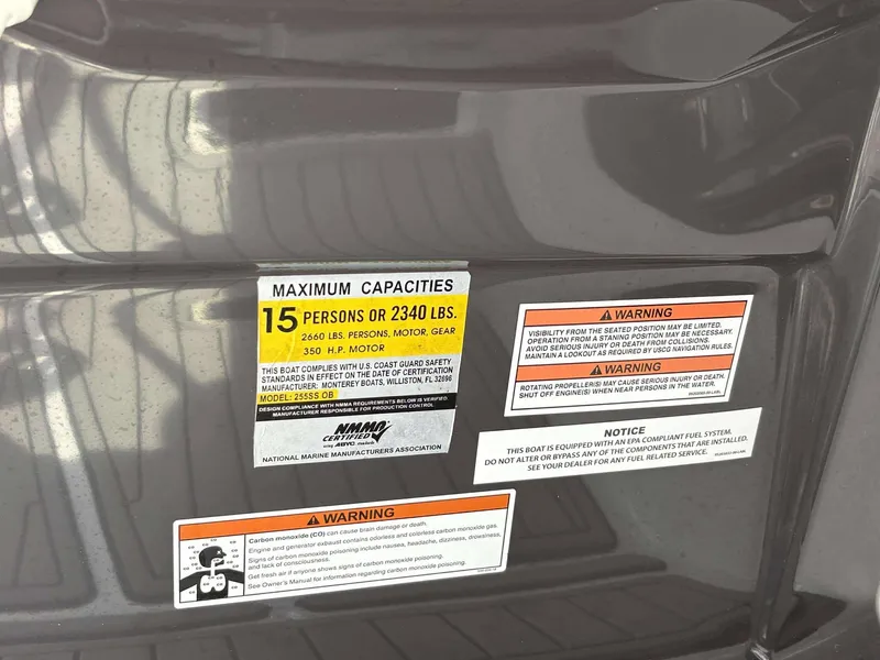 Slide: The Image of Warning labels on a 2021 Monterey 255 Super Sport boat, detailing capacity and safety information. - 17