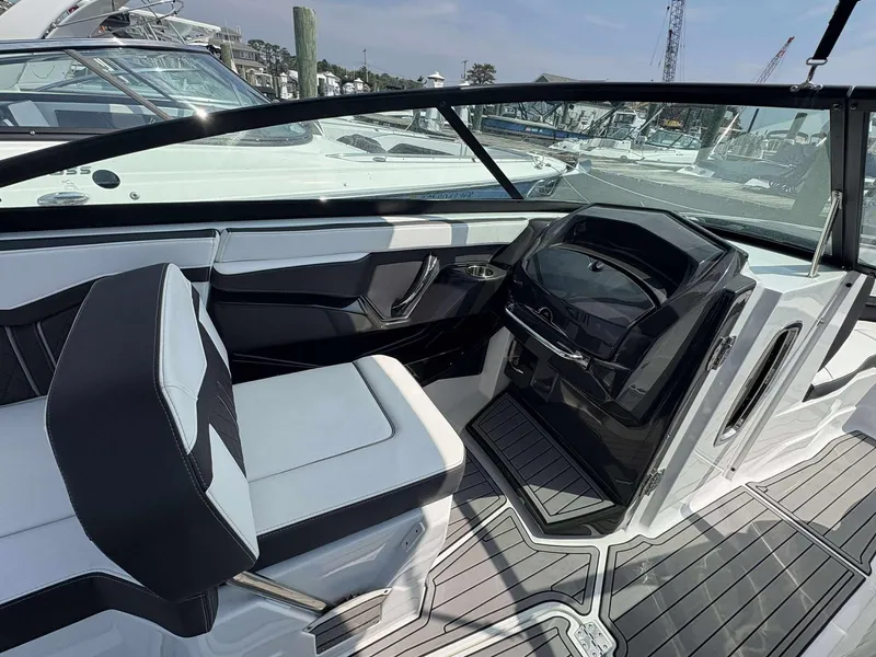 Slide: The Image of Interior of a 2021 Monterey 255 Super Sport boat, featuring sleek seating and modern dashboard. - 5