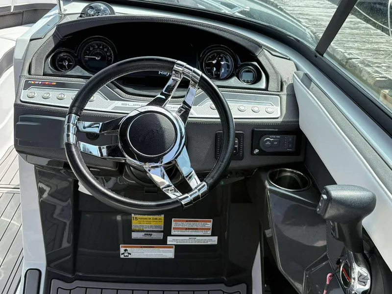 Slide: The Image of 2021 Monterey 255 Super Sport boat dashboard with steering wheel and control panel. - 6