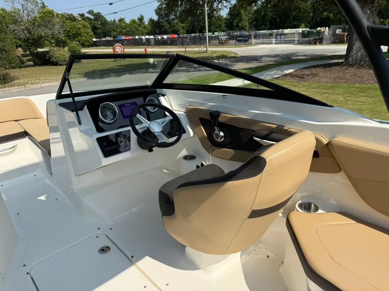 Slide: The Image of 2019 Sea Ray 21SPX boat interior with beige seating and modern dashboard. - 12