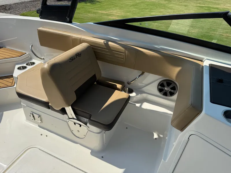 Slide: The Image of 2019 Sea Ray 21SPX boat interior with tan seating and cup holders. - 14