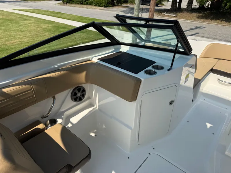 Slide: The Image of 2019 Sea Ray 21SPX boat interior with tan seating and sleek dashboard design. - 15