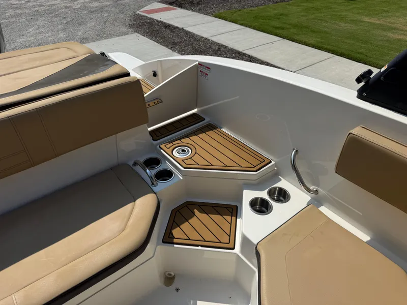 Slide: The Image of 2019 Sea Ray 21SPX boat interior with tan seating and cup holders. - 20