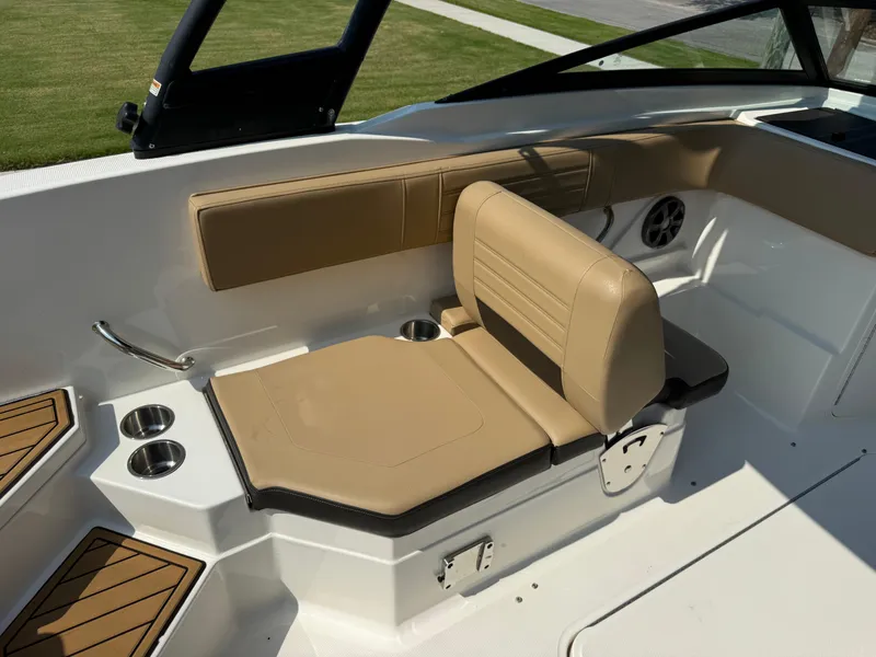 Slide: The Image of 2019 Sea Ray 21SPX boat interior with tan seating and cup holders. - 21