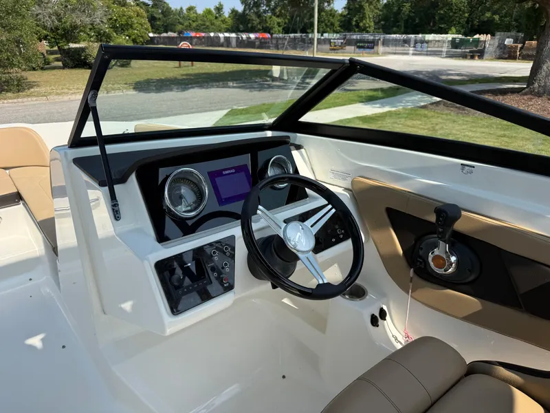 Slide: The Image of 2019 Sea Ray 21SPX boat dashboard with steering wheel and control panel. - 23