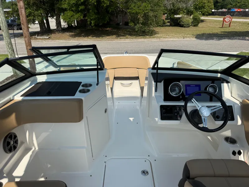 Slide: The Image of 2019 Sea Ray 21SPX boat interior with steering wheel and dashboard controls. - 24