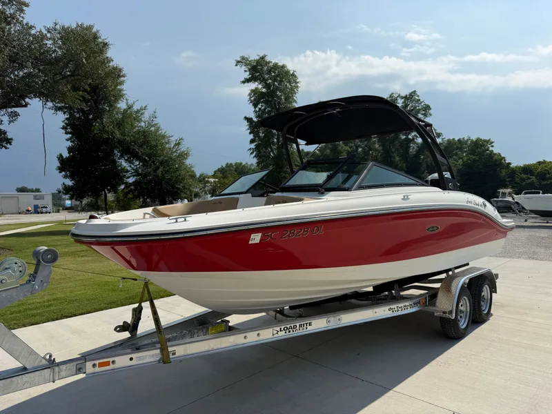 Slide: The Image of 2019 Sea Ray 21SPX boat on trailer, red and white, parked outdoors. - 3