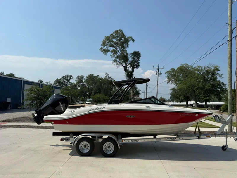 Slide: The Image of 2019 Sea Ray 21SPX boat on trailer, red and white design, parked outdoors. - 4
