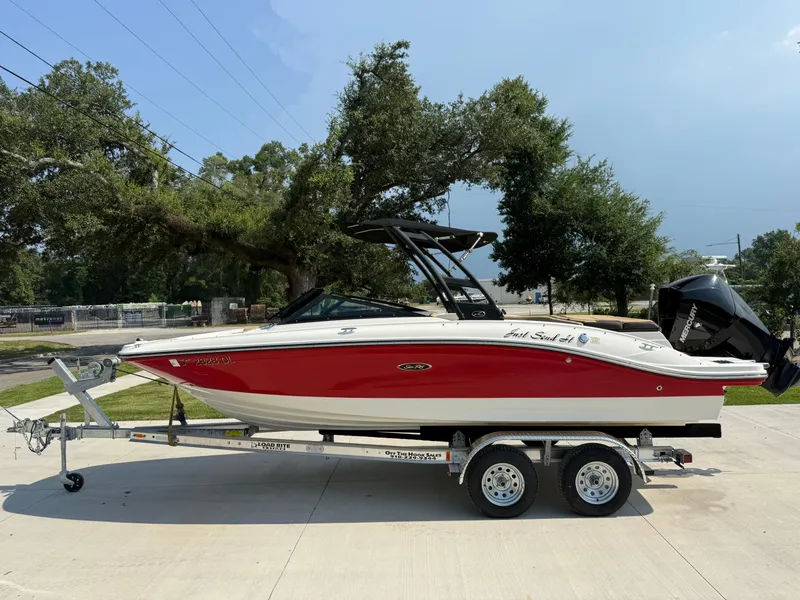 Slide: The Image of 2019 Sea Ray 21SPX boat on trailer, red and white design, parked outdoors. - 5