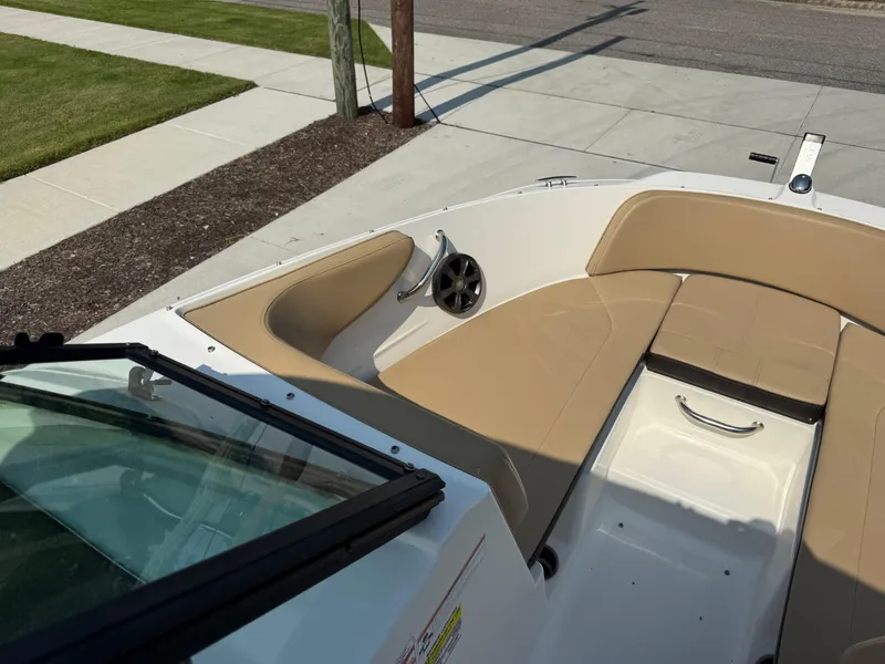 Slide: The Image of 2019 Sea Ray 21SPX boat interior with tan seating and speaker. - 7