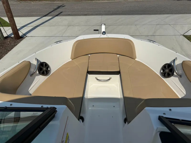 Slide: The Image of 2019 Sea Ray 21SPX boat interior with tan seating and speakers. - 8