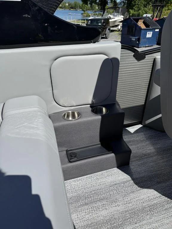 Slide: The Image of 2026 Bennington M Swingback 24 MSB boat interior with steering wheel and seating. - 17